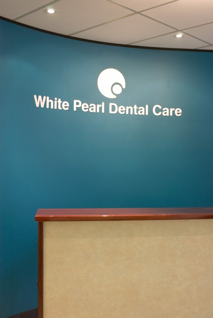 White Pearl Dental Care sign above the reception desk